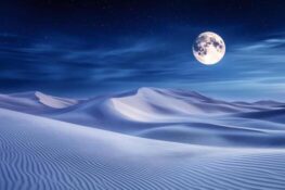 full-moon-illuminating-white-sand-dunes-in-desert-at-night-photo